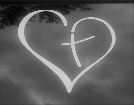 outline of white heart, with cross in centre, on black and white background